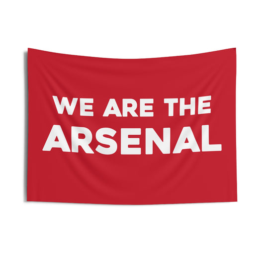 Arsenal FC team slogan banner with bold white text reading 'We Are the Arsenal' on a red background, symbolizing team pride and unity.