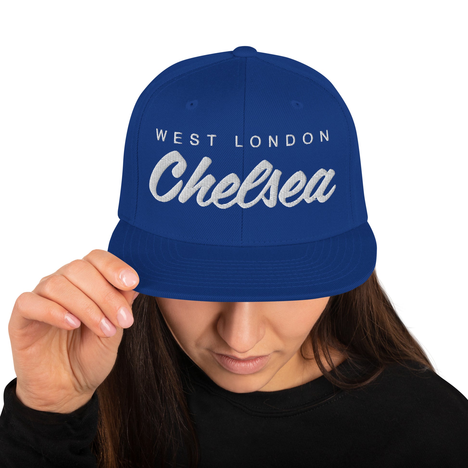 Blue vintage West London Chelsea FC snapback hat featuring a retro design with the club's name embroidered on the front of a flat bill cap, complete with an adjustable strap, showcasing official fan gear for Chelsea supporters